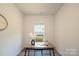 Bright office space featuring a modern wood desk, neutral decor, and a window for natural light at 3403 Keith Dr, Charlotte, NC 28269