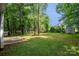 Large backyard featuring mature trees and lawn at 3826 Yorkford Dr, Charlotte, NC 28269