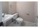 Cozy half bathroom with a pedestal sink and tile flooring at 3826 Yorkford Dr, Charlotte, NC 28269
