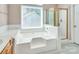 This bathroom features a large soaking tub with tile surround and walk-in shower with gold frame at 3826 Yorkford Dr, Charlotte, NC 28269