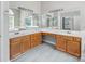 This bathroom features tile floors, corner mirrors, wood vanity with sinks, and neutral colored walls at 3826 Yorkford Dr, Charlotte, NC 28269