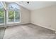 Bright bedroom featuring a vaulted ceiling, a large window, and a closet at 3826 Yorkford Dr, Charlotte, NC 28269