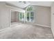 A carpeted bedroom with a vaulted ceiling, a window and a mirrored closet at 3826 Yorkford Dr, Charlotte, NC 28269