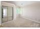 Cozy bedroom with vaulted ceilings, natural light, and a mirrored closet, perfect for storage at 3826 Yorkford Dr, Charlotte, NC 28269