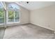 Bedroom featuring a vaulted ceiling, window, and mirrored closet for a bright and airy feel at 3826 Yorkford Dr, Charlotte, NC 28269