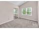 Bright bedroom offering a vaulted ceiling and natural light from the expansive window and closet at 3826 Yorkford Dr, Charlotte, NC 28269