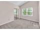 Neutral bedroom features a mirrored closet and a window with natural light at 3826 Yorkford Dr, Charlotte, NC 28269