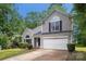Charming two-story home with a well-maintained front yard, attached two-car garage, and beautiful trees at 3826 Yorkford Dr, Charlotte, NC 28269