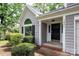 Close up of front door with brick trim and well-maintained front yard landscaping at 3826 Yorkford Dr, Charlotte, NC 28269