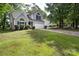 Charming home with manicured front lawn, arched windows, an attached garage, and mature trees at 3826 Yorkford Dr, Charlotte, NC 28269