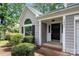 Inviting front entrance with neatly trimmed bushes, house number, and covered porch at 3826 Yorkford Dr, Charlotte, NC 28269