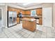 Eat-in kitchen with tile floors, wood cabinets, and stainless steel appliances at 3826 Yorkford Dr, Charlotte, NC 28269