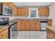 A kitchen featuring oak cabinets, granite countertops and stainless steel oven, microwave and dishwasher at 3826 Yorkford Dr, Charlotte, NC 28269