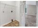 Practical laundry area with storage shelving and a view of the adjacent carpeted room at 3826 Yorkford Dr, Charlotte, NC 28269