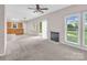 Sunlit living room with a fireplace, large windows, and access to the backyard at 3826 Yorkford Dr, Charlotte, NC 28269
