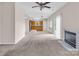 Bright living room featuring a fireplace, ceiling fan, and kitchen access, with sliding door at 3826 Yorkford Dr, Charlotte, NC 28269