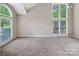 Bright and airy living room with large windows and neutral walls at 3826 Yorkford Dr, Charlotte, NC 28269