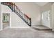 Open concept living room with staircase and view to a tiled entryway at 3826 Yorkford Dr, Charlotte, NC 28269