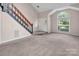 Spacious living room with vaulted ceiling, tile entryway, and staircase at 3826 Yorkford Dr, Charlotte, NC 28269