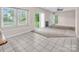 Open living area with plush carpet, a fireplace, and large windows that let in natural light at 3826 Yorkford Dr, Charlotte, NC 28269