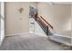 Spacious living room with high ceilings, staircase, and neutral carpet at 3826 Yorkford Dr, Charlotte, NC 28269