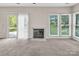 Sunny living room featuring a fireplace, lots of windows, and a sliding door at 3826 Yorkford Dr, Charlotte, NC 28269