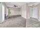 A bright living room space featuring tan carpet flooring and a ceiling fan and neutral walls at 3826 Yorkford Dr, Charlotte, NC 28269
