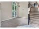 Bright living room with large windows, high ceilings, and elegant chandelier at 3826 Yorkford Dr, Charlotte, NC 28269
