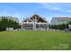 Expansive backyard featuring a pool, outdoor kitchen, a fenced yard and a spacious lawn at 4049 Shadowbrook Rd, Waxhaw, NC 28173