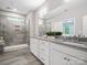 Modern bathroom with a dual-sink vanity, granite countertop and a glass-enclosed shower at 4049 Shadowbrook Rd, Waxhaw, NC 28173