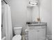 Well-lit bathroom featuring a single sink vanity with granite countertop and a shower/tub combination at 4049 Shadowbrook Rd, Waxhaw, NC 28173