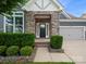Charming home featuring a stone-accented entrance, covered porch, and manicured landscaping at 4049 Shadowbrook Rd, Waxhaw, NC 28173