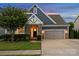 Charming two-story home with stone accents, a well-manicured lawn, and a convenient two-car garage at 4049 Shadowbrook Rd, Waxhaw, NC 28173