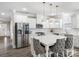 Bright, open kitchen with stainless steel appliances, pendant lighting and a large island at 4049 Shadowbrook Rd, Waxhaw, NC 28173