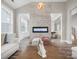 Modern living room with decorative fireplace, neutral color palette and an open floor plan at 4049 Shadowbrook Rd, Waxhaw, NC 28173