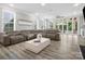 The living room flows to the outside with a wall of sliding doors to the covered porch and pool at 4049 Shadowbrook Rd, Waxhaw, NC 28173