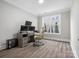 Bright home office featuring hardwood floors, modern desk and a large window at 4049 Shadowbrook Rd, Waxhaw, NC 28173