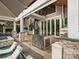 Well-appointed outdoor space featuring a kitchen, spiral staircase, poolside lounge chairs, and comfortable seating area at 4049 Shadowbrook Rd, Waxhaw, NC 28173