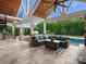 Inviting outdoor space with a comfortable seating area, outdoor kitchen, and a refreshing pool view at 4049 Shadowbrook Rd, Waxhaw, NC 28173