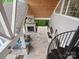Aerial view of covered patio with fireplace, outdoor seating and stone flooring with spiral staircase access at 4049 Shadowbrook Rd, Waxhaw, NC 28173