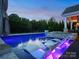 Inviting pool with in-water loungers and a tranquil backyard setting with lush greenery at 4049 Shadowbrook Rd, Waxhaw, NC 28173