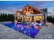 Stunning outdoor space with a pool, lounge chairs, outdoor kitchen, and spiral staircase under vaulted ceilings at 4049 Shadowbrook Rd, Waxhaw, NC 28173