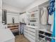 This is an organized walk-in closet with built-in shelves and drawers for optimal storage space at 4049 Shadowbrook Rd, Waxhaw, NC 28173