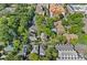 Aerial view of a residential neighborhood featuring mature trees, houses, some with pools, and apartment buildings at 409 W 8Th St, Charlotte, NC 28202