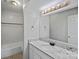 Modern bathroom featuring a granite vanity and tiled shower and tub area, offering a clean and updated space at 409 W 8Th St, Charlotte, NC 28202