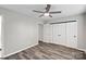 Bedroom with modern ceiling fan, wood-look flooring, large closet, and neutral paint at 409 W 8Th St, Charlotte, NC 28202