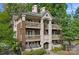 Stunning condo building with brick and painted accents, multiple decks, manicured landscaping, and a welcoming entrance at 409 W 8Th St, Charlotte, NC 28202
