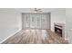 Comfortable living room with a fireplace and access to an outdoor space, featuring laminate floors at 409 W 8Th St, Charlotte, NC 28202