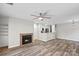 Cozy living room featuring a brick fireplace and wood flooring, complemented by an open kitchen layout at 409 W 8Th St, Charlotte, NC 28202