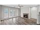 Living room featuring a fireplace, access to outdoor space, and laminate floors offering a cozy atmosphere at 409 W 8Th St, Charlotte, NC 28202